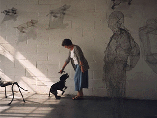 Portrait of Livia Rolandini in her studio with wire mesh sculpture